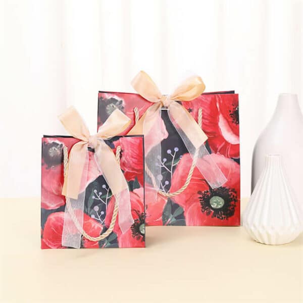 display two red custom colorful gift paper bags with ribbon bow in different sizes