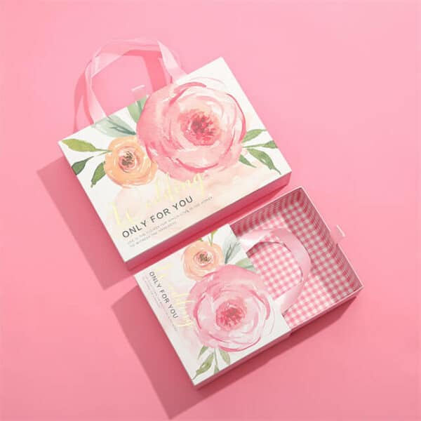 Mostrar dos cajas rígidas de cajones deslizantes de regalo de ropa de lujo personalizadas rosas