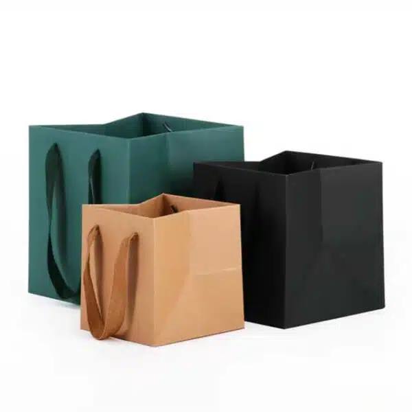 display three custom square kraft paper bags with rope handles in different sizes and colours