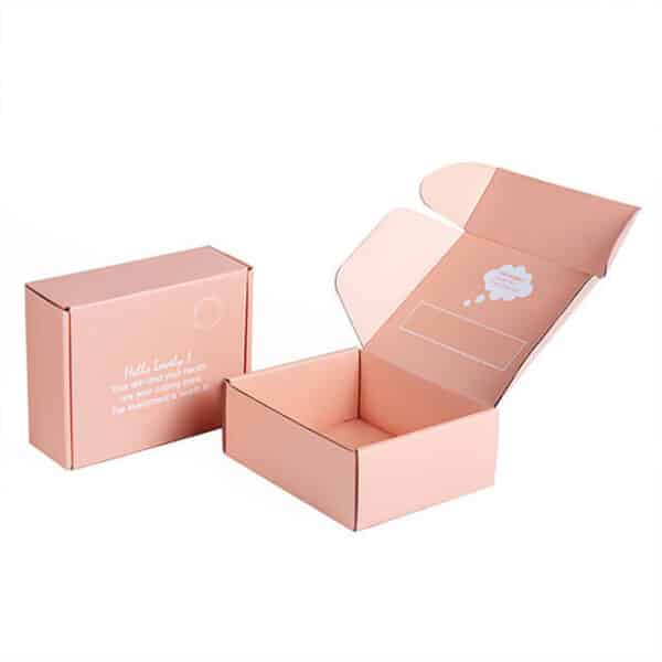 display two pink custom tuck top mailer carton boxes, one is closed one is open