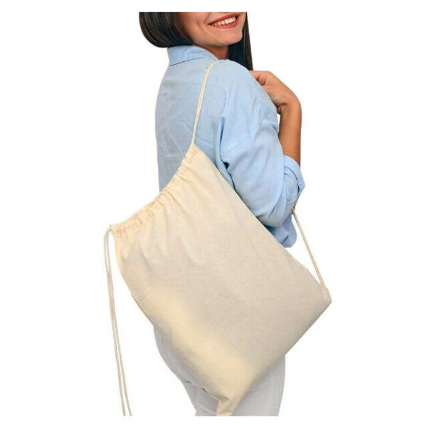 didelis pagal užsakymą pagamintas drobinis maišelis su virvele, nešiojamas ant moters peties
