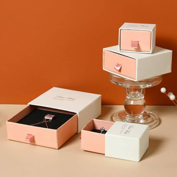 display a bunch of white and pink custom logo printed jewelry drawer boxes in different sizes