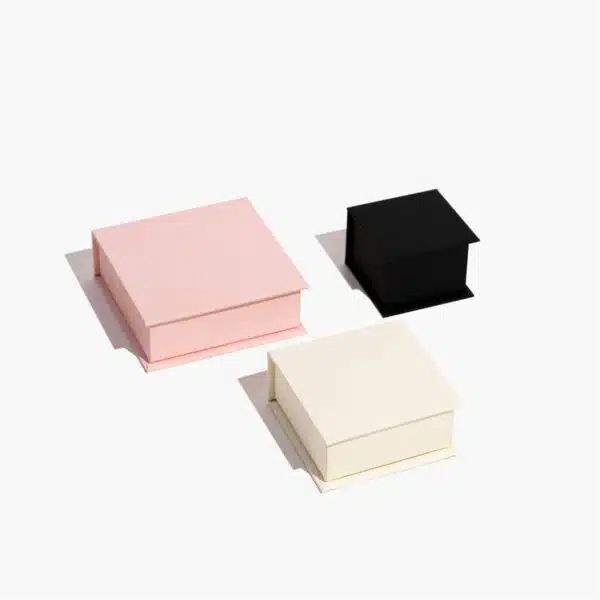 three closed well-made custom magnetic jewelry boxes with pink, white, black, and different size