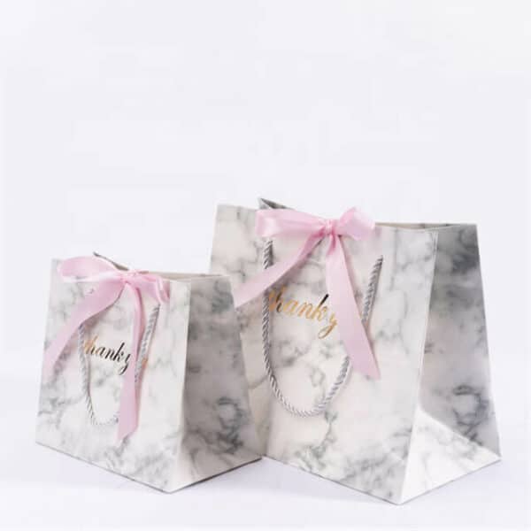 display two custom colorful gift paper bags with ribbon bow in different sizes