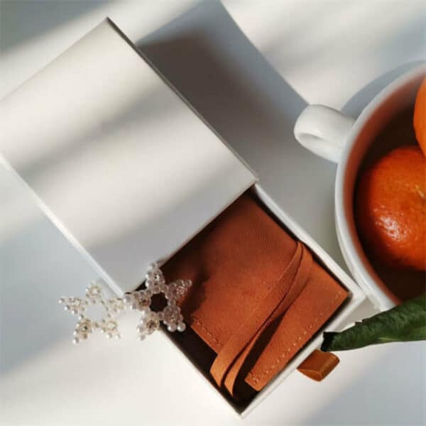display one custom eco-friendly 2 piece rigid box with an orange microfiber jewelry pouch inside