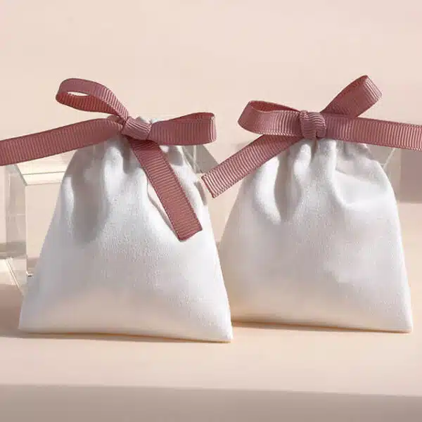 display two white Custom Flannel Ribbon Pouches with ribbon bow