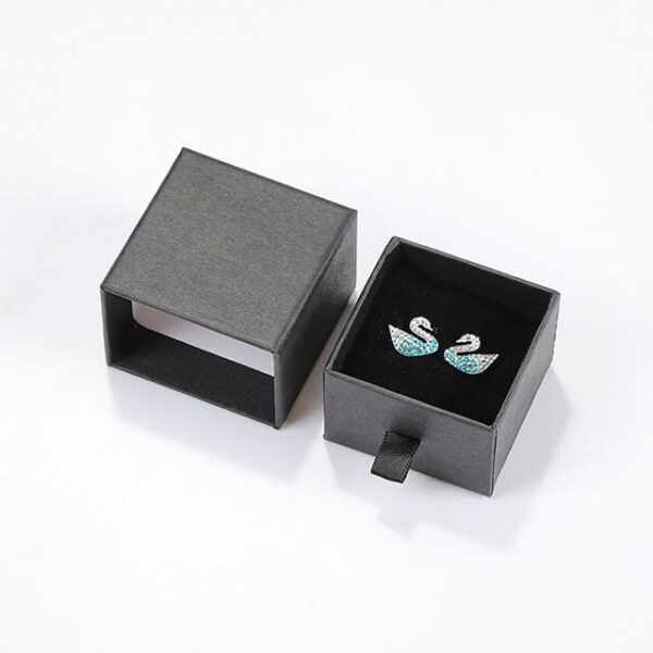 rodyti juodą individualų kartoninį auskarų stalčių dėžutę su pora auskarų viduje