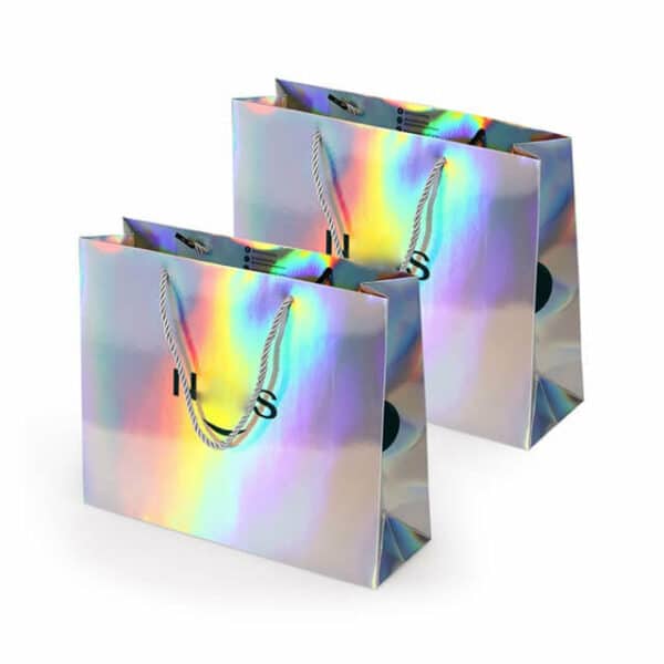 mostrar dos bolsas de papel holográficas personalizadas con asas de cuerda en fila