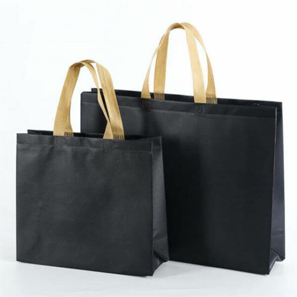 display two black custom large commerce non woven tote bags in different sizes