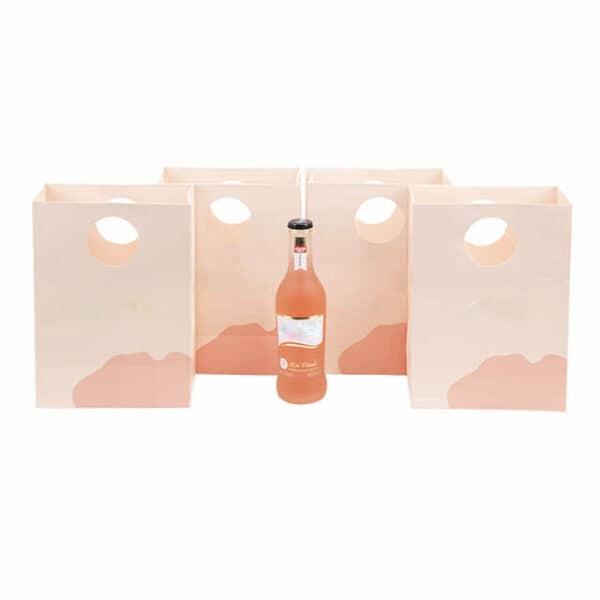 display four custom paper bags with round die-cut handles and a bottle of drink in the middle of them