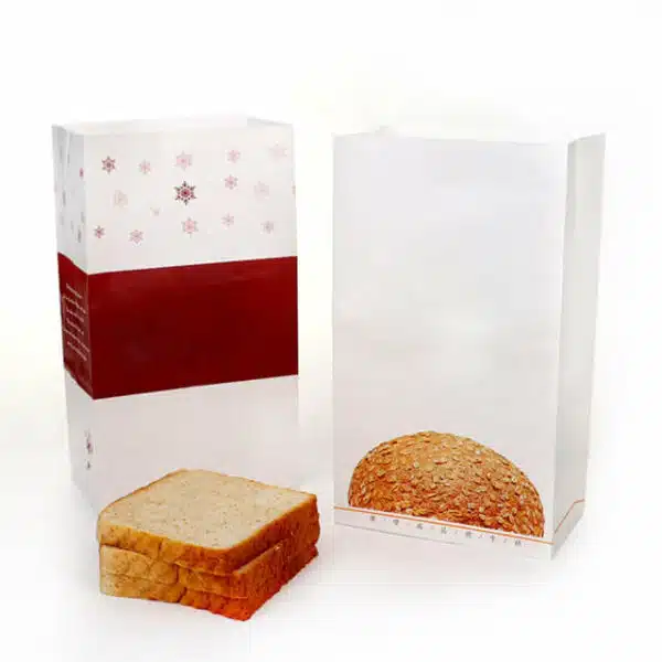 pokazati dvije prazne prilagođene SOS papirnate vrećice za pakiranje kruha s komadićima kruha pored