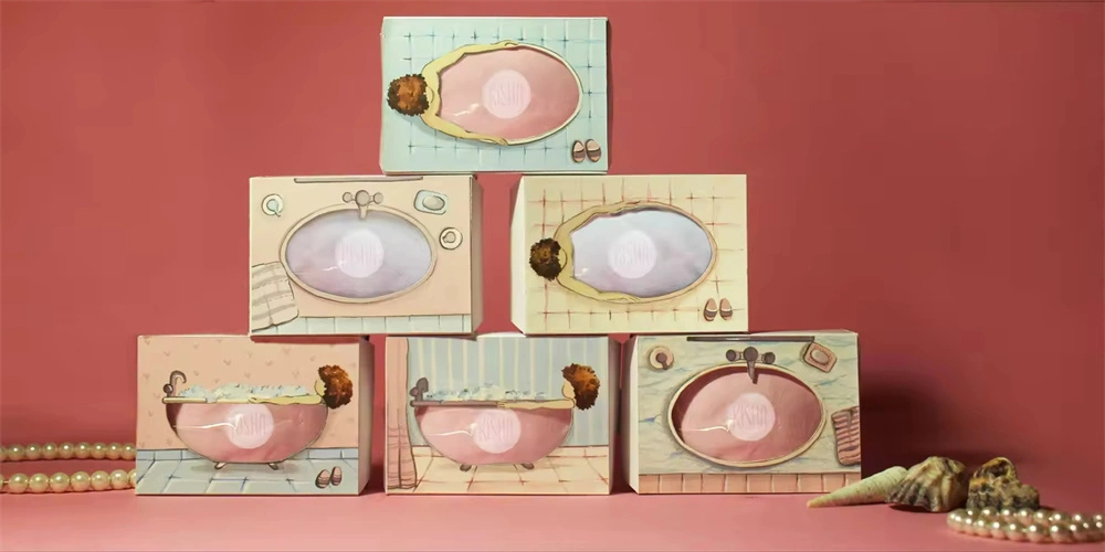 An artistic display featuring pastel-colored paintings of vintage bathtubs and sinks in custom soap packaging, with soap and pearls incorporated into the scenes, set against a red backdrop.