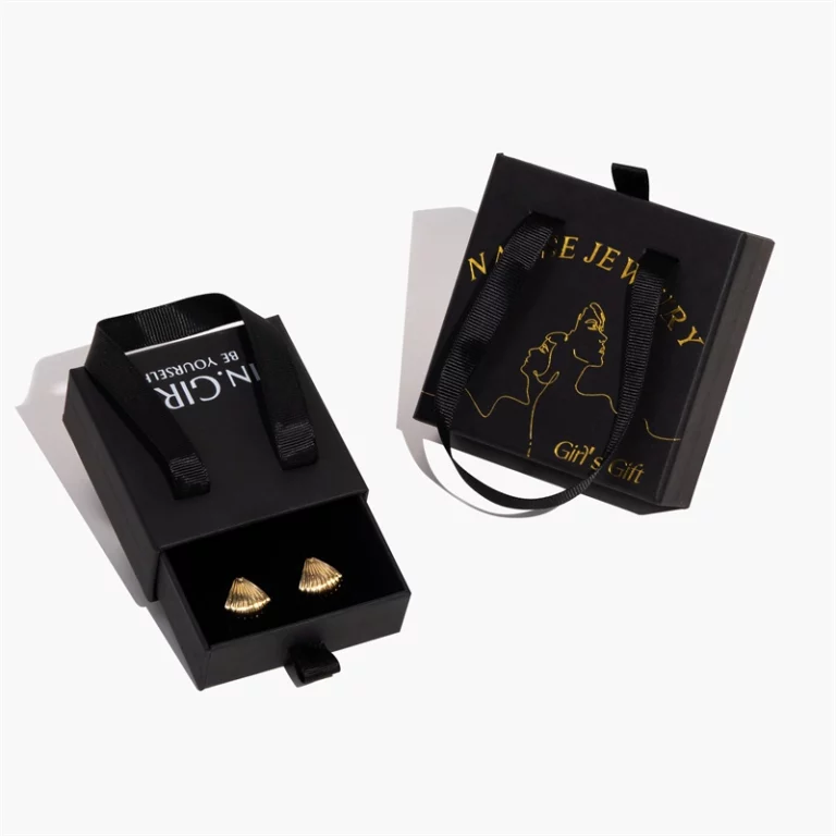 ორი შავი მორგებული ხისტი უჯრის სამკაულების ყუთი სახელურებით, ერთი ღიაა საყურეებით შიგნით, მეორე დგას მის მარჯვნივ