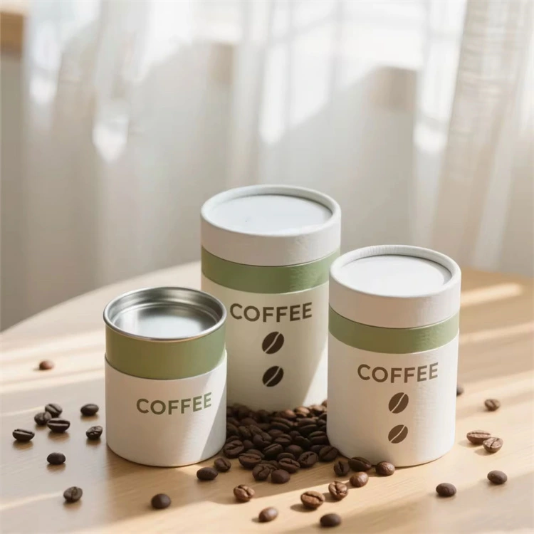 there are three cardboard tubes and one is shown with the metal caps, and there are coffee beans scatter around them