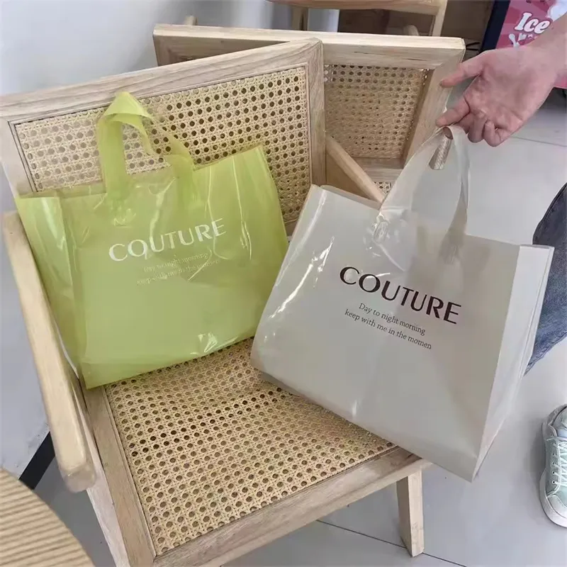 there are two Vinyl tote bags one a chair, one is green and another is grey