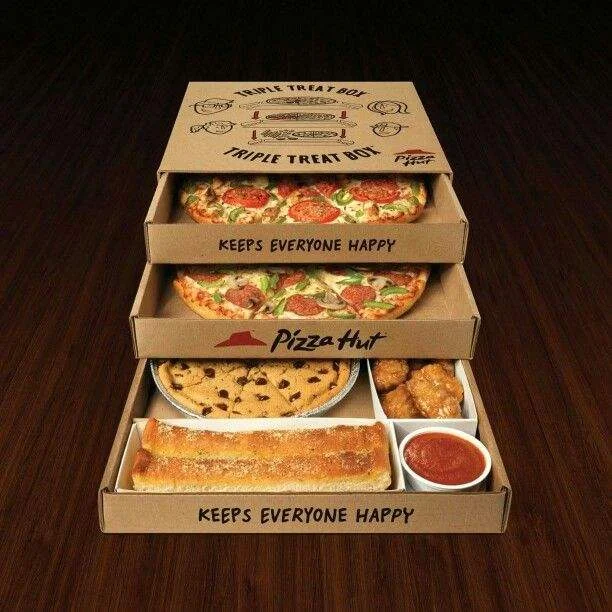 a three-layer pizza box with two pizza and some other food inside