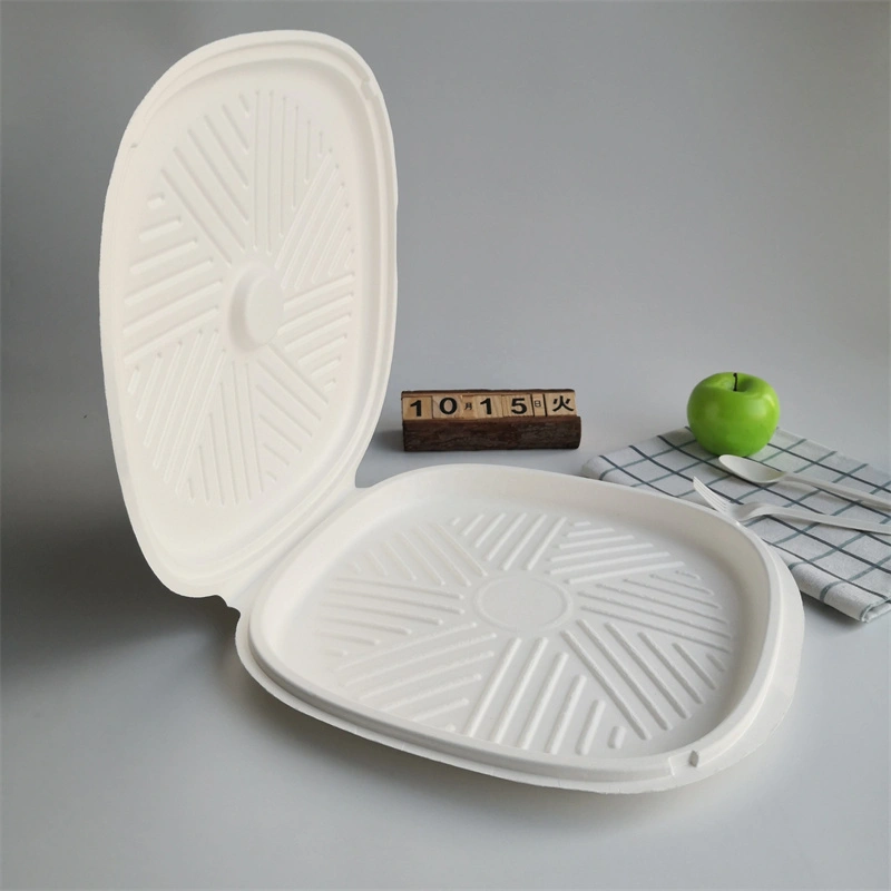 there is a round pizza box, a green aple, a fork and spoon，a napkin